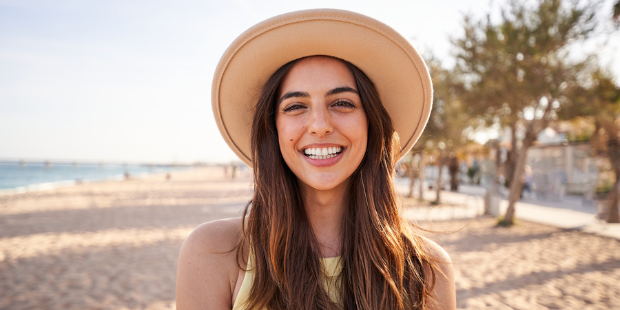 A woman smiling and thinking about LASIK costs