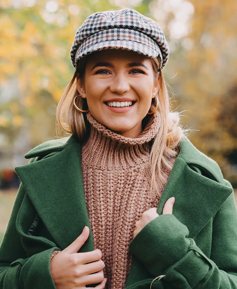 Fashionable blonde female enjoying a sunny autumn day outdoors